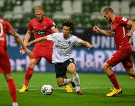 Bremens Osako im Kampf um den Ball gegen drei Heidenheimer.